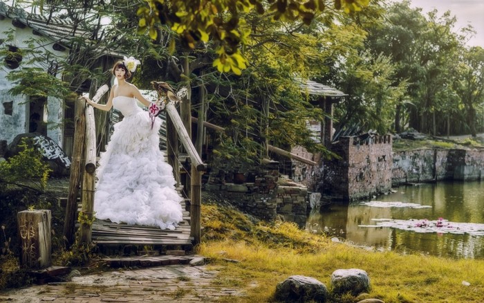 Bride with eagle on a wooden bridge
