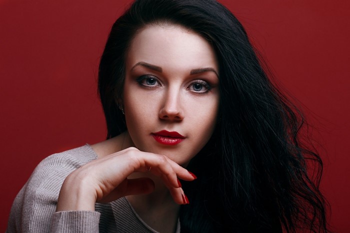 Woman with black hair and red lipstick