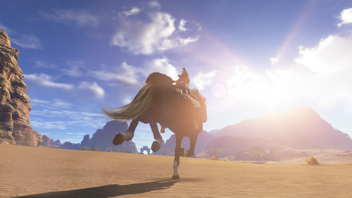 Person riding a horse in a desert landscape