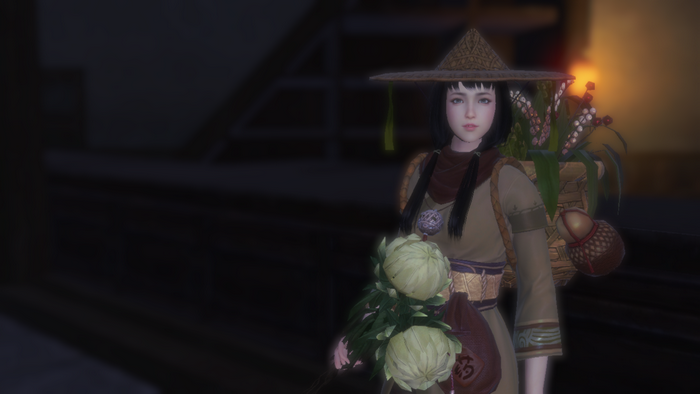 A woman in a conical hat holding flowers