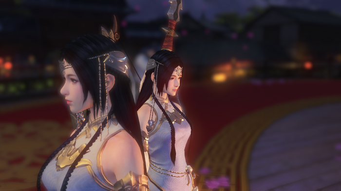 Two women in traditional Chinese attire on a stage