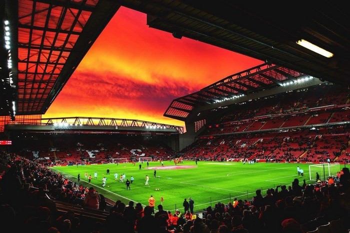Soccer stadium with a dramatic red sunset sky