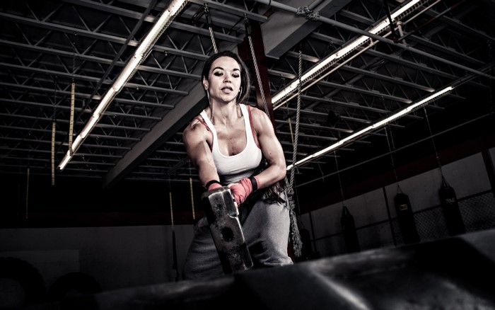Woman with Sledgehammer in Gym
