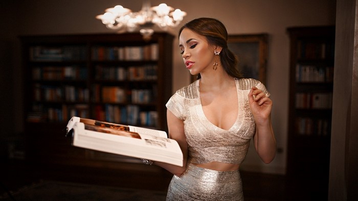 Elegant Woman Reading Book in Warm Library