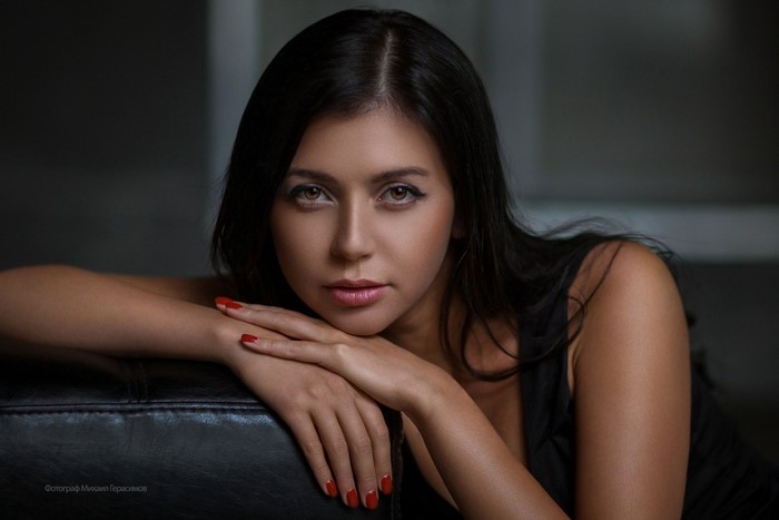 Woman with long black hair and red nails