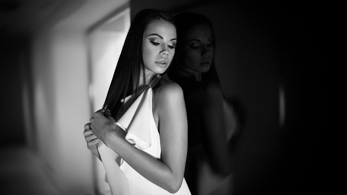 Monochrome portrait of a woman in a white dress