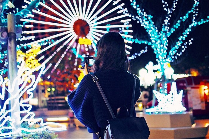 Woman taking a photo of Christmas lights in Yokohama