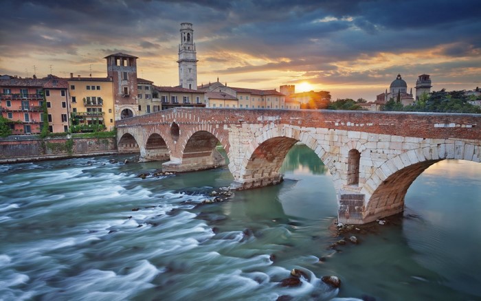 Ponte Pietra bridge over Adige River in Verona, Italy at sunset