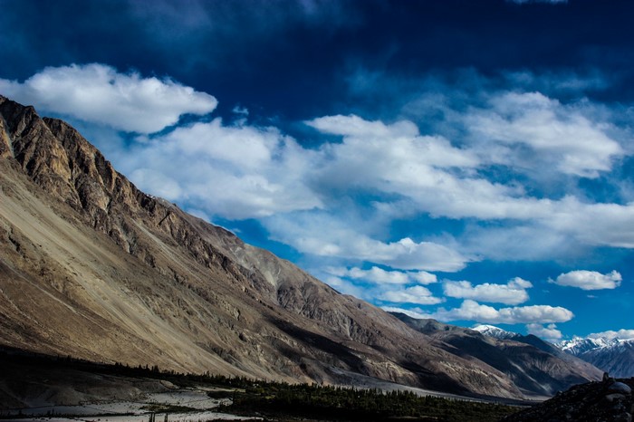 Mountain range under a cloudy blue sky