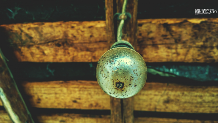 Close up of a dirty lightbulb hanging from a rope