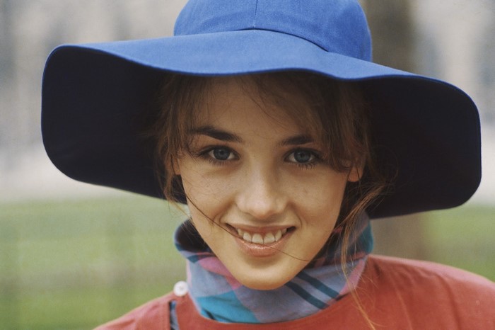 Isabelle Adjani wearing a blue hat and scarf