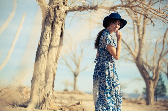 Sara Malakul Lane in a blue dress outdoors