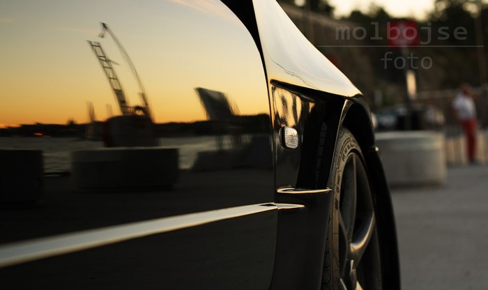 Black Nissan Skyline GT-R R34 reflection at sunset