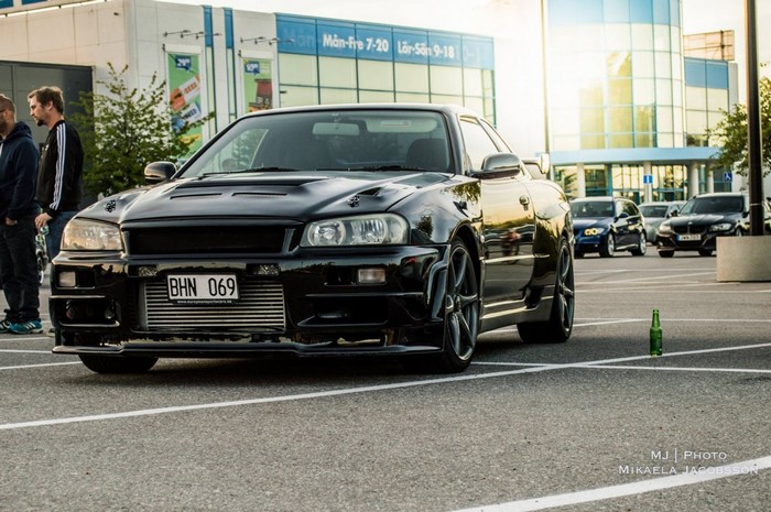 Black Nissan Skyline GT-R R34 in parking lot