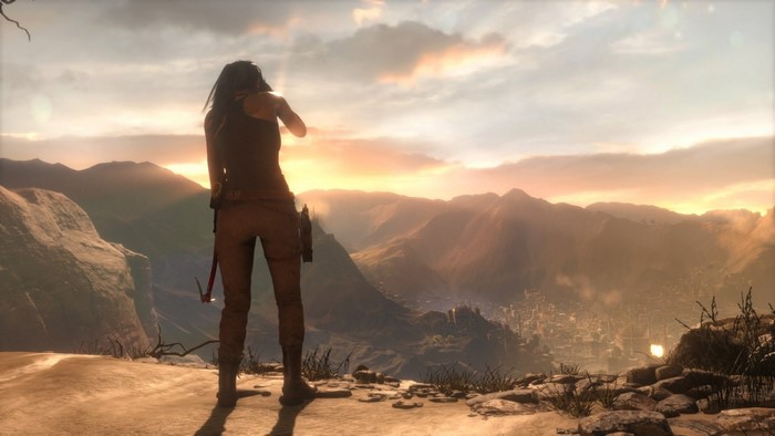 Lara Croft from Tomb Raider overlooking a valley at sunset