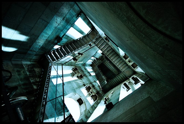 Looking up a spiral staircase in a stone tower