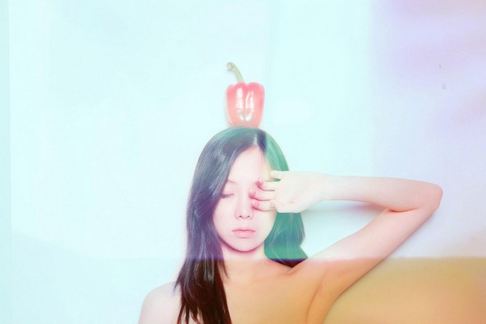 Woman with red pepper on head