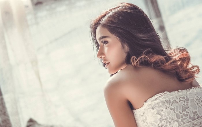 Woman in white dress with brown hair
