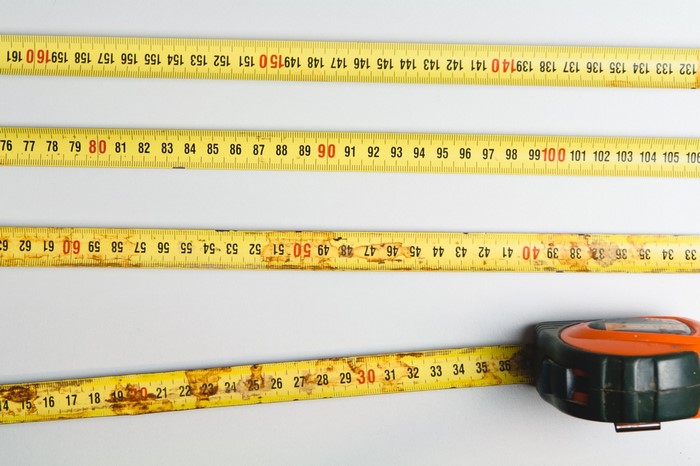 Measuring tapes with rust on white background