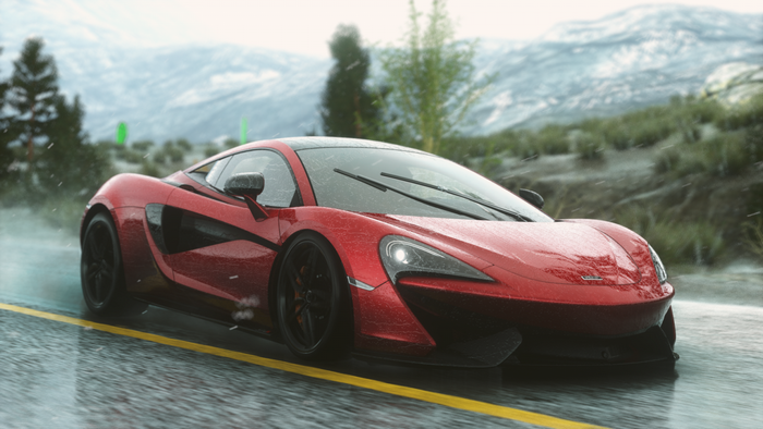 Red McLaren sports car driving on a wet road