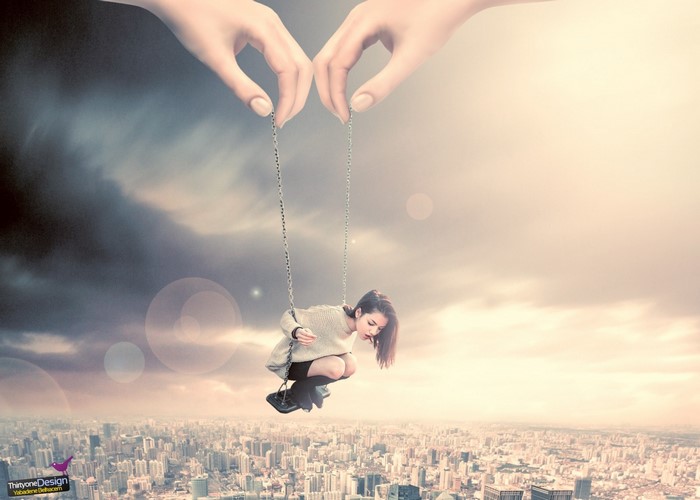 Giant hands holding a woman on a swing over a city