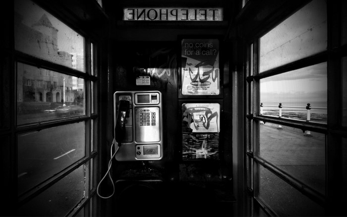 Black and white photo of a telephone booth interior