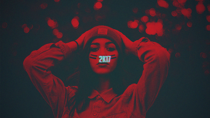 Woman with 2K17 on face and red bokeh