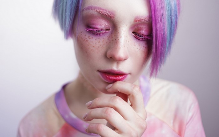 Woman with pink and blue dyed hair and makeup