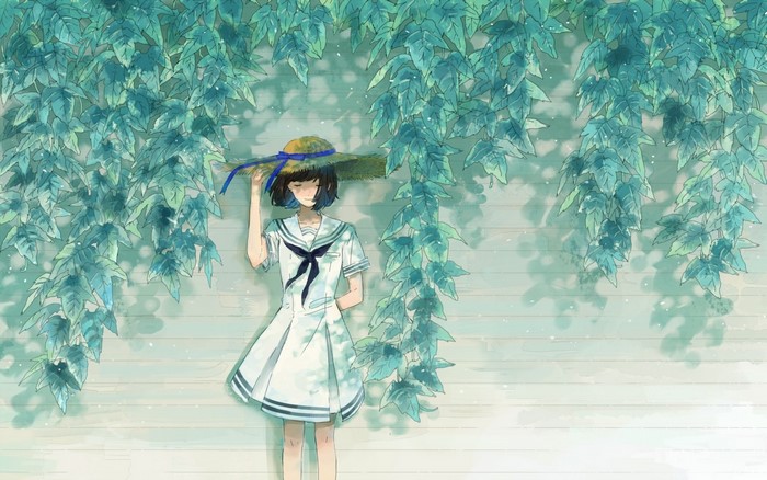 Girl in a sailor dress and sun hat under leaves