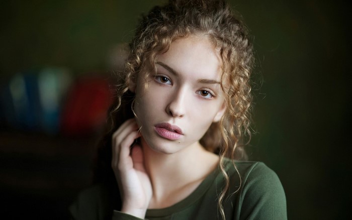 Portrait of a young woman with curly hair