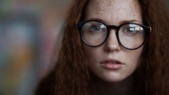 Woman with freckles wearing glasses