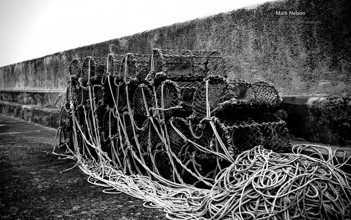 Lobster pots and ropes on a concrete wall
