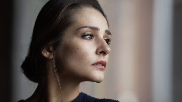 Woman with freckles looking to the side