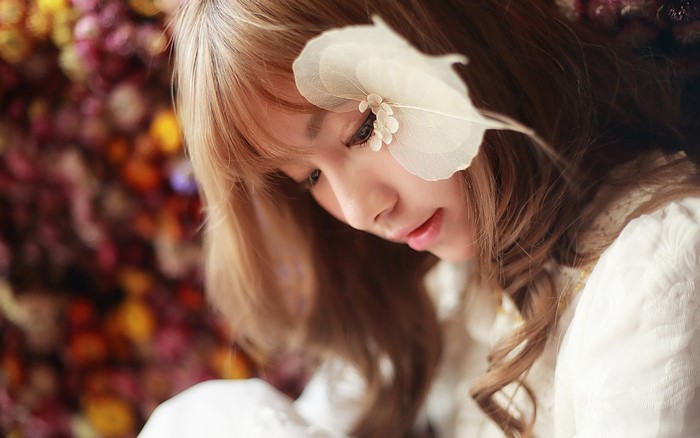 Close up portrait of a young woman with a flower accessory