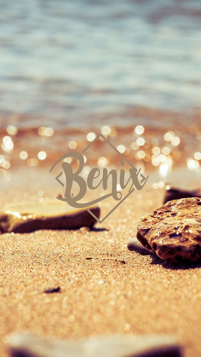 Benix logo on a beach with rocks and water