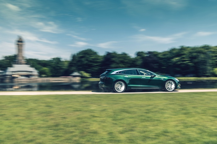 Green Tesla Model S Shooting Brake driving on a road