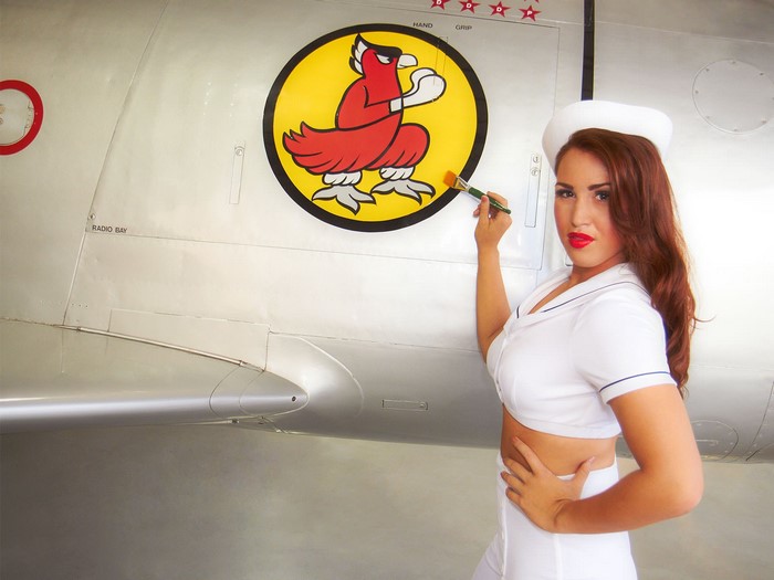 Woman in sailor outfit painting on airplane