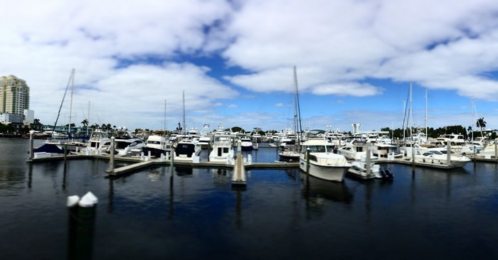 Boats docked in a marina under a cloudy sky