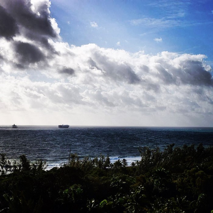 Ships on the ocean under a cloudy sky
