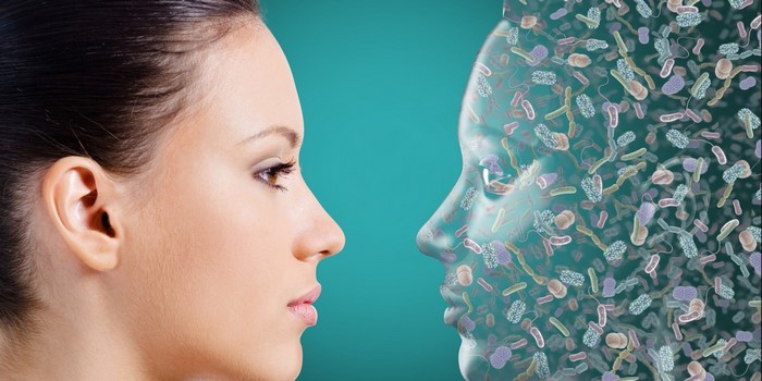 Woman's face and a head filled with bacteria