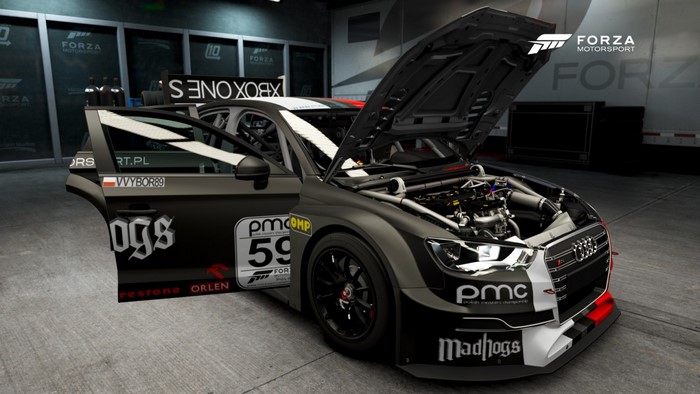 Audi RS3 LMS TCR race car with open hood and doors
