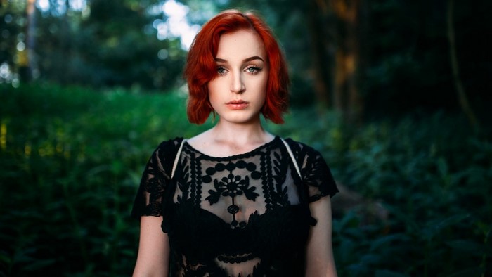 Redhead woman in black lace top outdoors