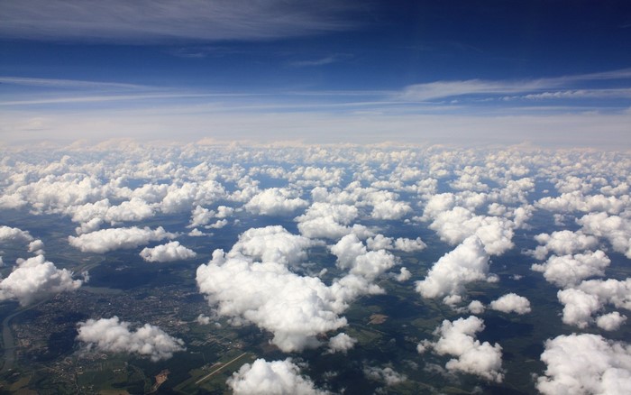 Aerial view of clouds over land and river