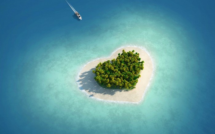 Heart-shaped island in the ocean with a boat