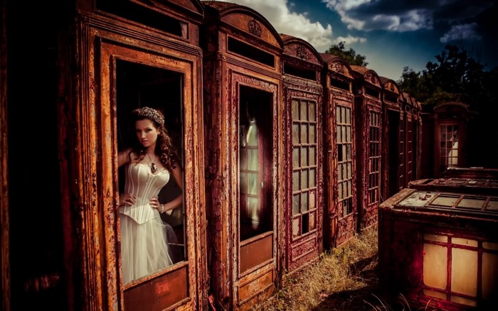 Woman in corset and dress in abandoned train cars