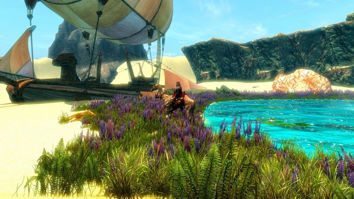 A person rides a horse through a field of purple flowers near a ship and a body of water.