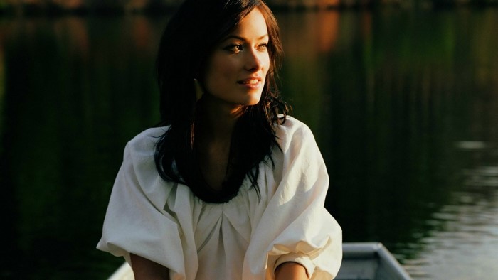 Olivia Wilde in a white dress on a boat