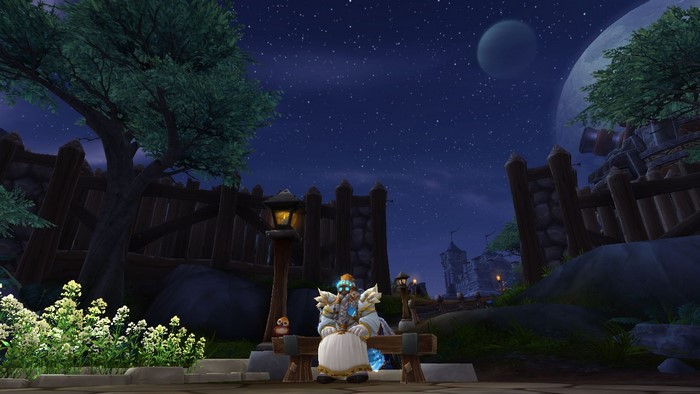 Dwarf Priest sitting on a bench in World of Warcraft at night