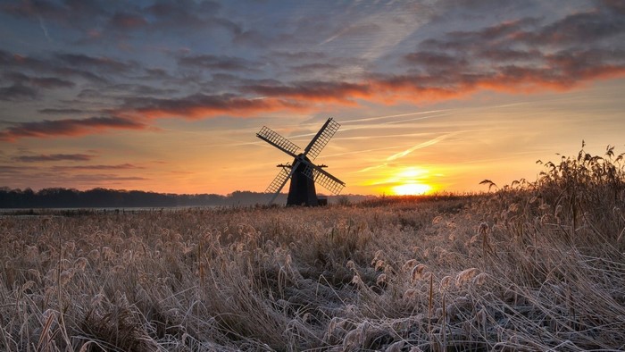Windmill in a frosty field at sunrise