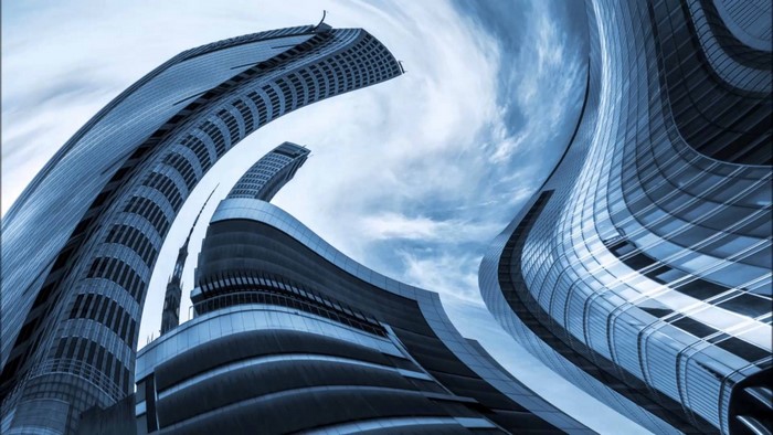 Abstract architecture of distorted skyscrapers against a cloudy sky